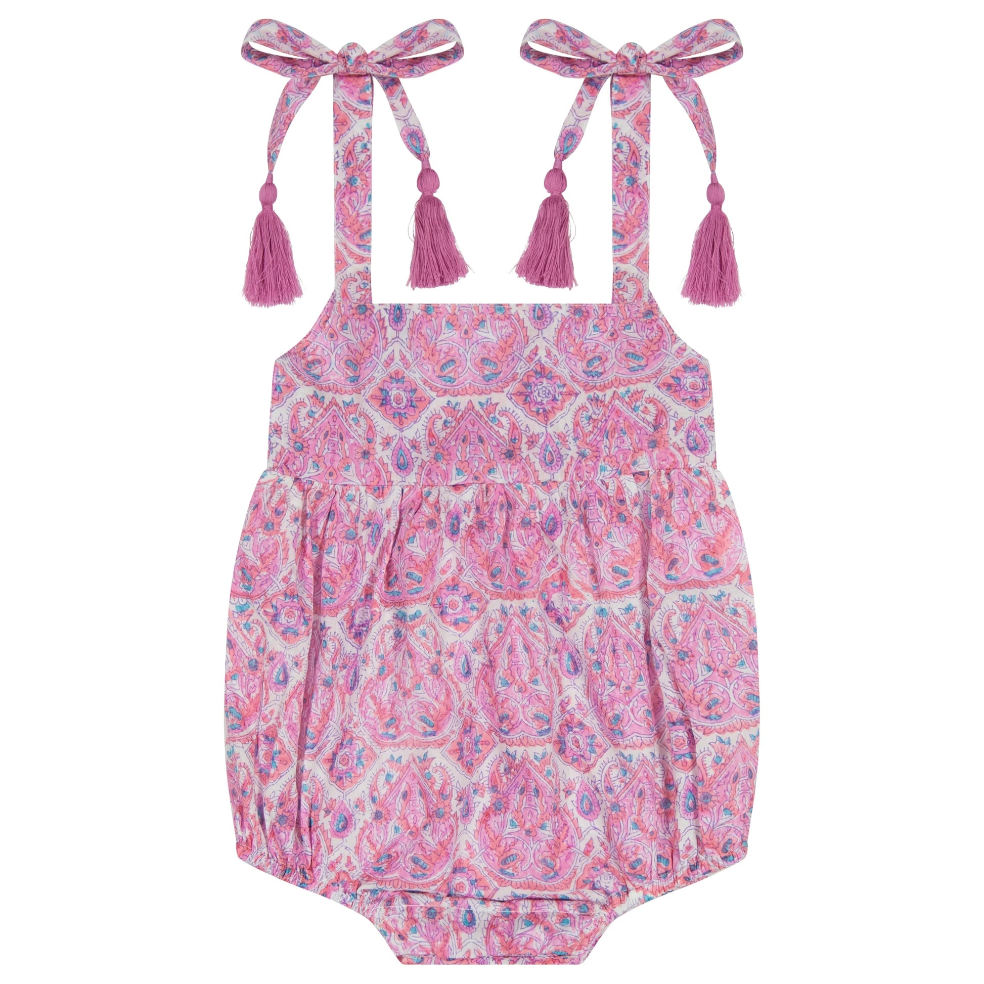 The Mer Baby Girls' Zoe Romper features a pink paisley pattern, shoulder tie accents, and playful tassel details, shown flat on a white background.