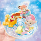 Three small baby figures from Calico Critters’ Baby Mermaid Castle wear pastel outfits as they ride animal-shaped floats through swirling water, set against a blue, bubbly backdrop that captures the enchantment of a sea-themed amusement park.