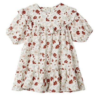 The Girls' Cordelia Dress by Rylee & Cru is a short-sleeved ruffle dress with elasticized sleeves and a white base decorated with red and beige floral patterns.