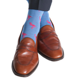 Brown leather loafers paired with Dapper Classics Flamingo Cotton Mid Calf Socks in Azure Blue with Coral. These stylish socks are crafted from mercerized cotton for a smooth finish, ensuring both comfort and style. Made in the USA, they add a whimsical touch to any ensemble.