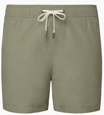 The Charles 5" Swim Trunk by Onia features a light olive green hue, classic tailoring, elastic waistband, white metal-tipped drawstring, and quick-dry fabric, shown against a plain background.