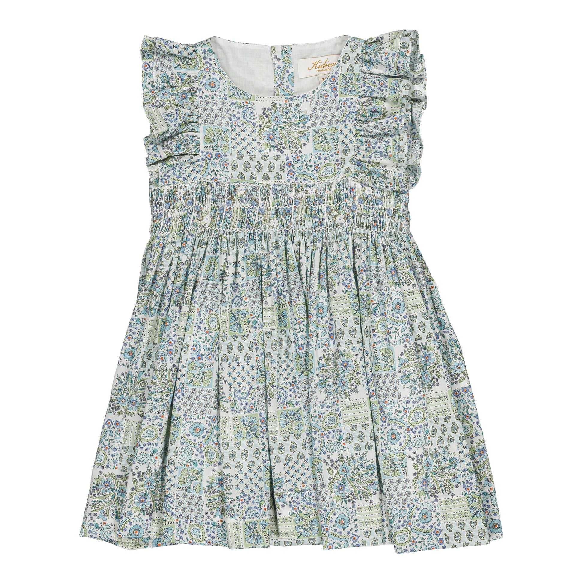 The Kidiwi Baby Girls' and Girls' Clarisse Smocked Dress features a sleeveless design in light green and white with floral and geometric patterns, ruffled shoulders, and a gathered waist in soft cotton poplin, shown on a plain white background.