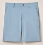The Johnnie-O Fusionn Short is a light blue men’s performance chino short, crafted from stretch-knit fabric for enhanced comfort. It features side pockets, belt loops, and a front button closure, all showcased against a plain background.