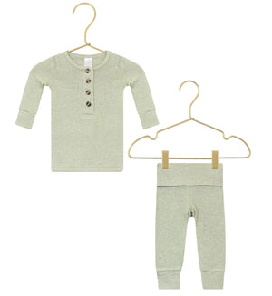 The Lou Lou & Company Baby Collins Plush Knit Top & Bottoms set, shown in light green, features a long-sleeve button-up shirt and matching pants with a fold-over waistband, both displayed on gold hangers against a white background.
