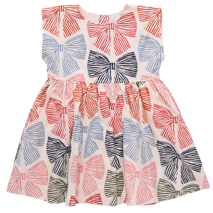 The Girls' Adaline Dress by Pink Chicken is a sleeveless kids' dress with large multicolored striped bows on a crisp white background.