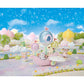 Calico Critters’ Floral Fantasy Skyship carries miniature animal friends, like the Latte Cat baby dressed in a delicate fairy costume, as they soar in a pastel-colored carriage adorned with balloons through a whimsical outdoor scene beneath a blue sky filled with clouds and stars.