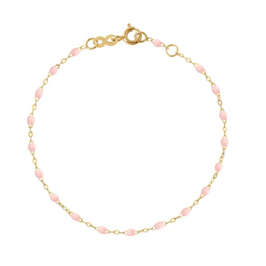 The Gigi Clozeau Little Gigi Classic Bracelet 5.1" showcases a gold chain adorned with pink oval beads and a secure clasp, crafted from 18 carat gold.