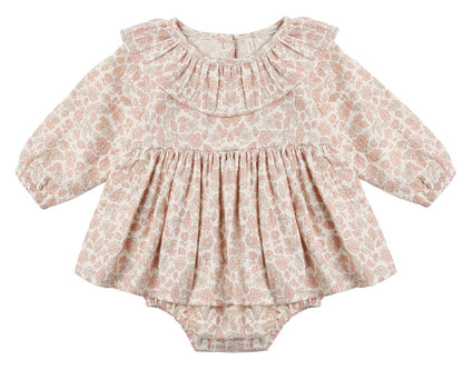 The Quincy Mae Baby Girls’ Thalia Romper features long sleeves, a ruffled collar, and a delicate pastel pink and beige floral pattern with charming embroidery, showcased against a plain white background.