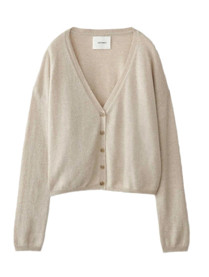 The Lisa Yang Abby Cashmere Cardigan, with long sleeves and a button-up front, lays flat to display its beige hue, V-neck design, and featherweight cashmere fabric. Its loose-fitted silhouette makes it an ideal trans-seasonal essential.