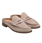 The Carissa Suede Mule Penny by Magnanni is a beige suede women’s loafer-style mule featuring low wooden heels and visible stitching details.