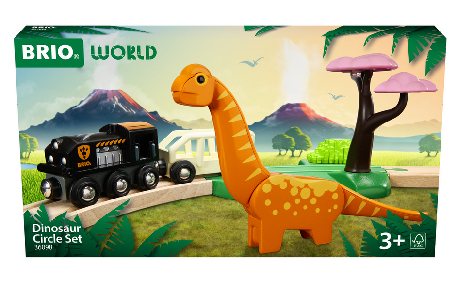 A photograph of the BRIO World Dinosaur Circle Set by Brio, showcasing a dinosaur-themed train set complete with a toy train, a dinosaur figure, a pink tree, and a mountainous landscape background. Recommended for ages 3 and up.