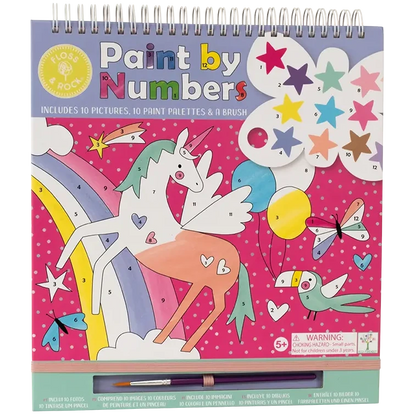 The Floss and Rock Fantasy Paint By Numbers kit is a spiral-bound art set for kids ages 5 and up, featuring a vibrant pink background with polka dots, and playful designs including a colorful unicorn, rainbow, stars, bird, and paintbrush.