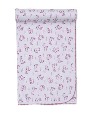 White baby blanket from Kissy Kissy, crafted from ultra-soft Pima cotton and edged with pink stitching, features the Whale Pods design with a charming pink and purple motif, rolled at the top.