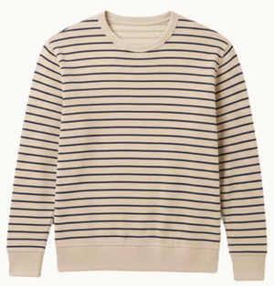The Faherty Double Knit Crewneck is a beige sweater made from soft Pima cotton with even navy stripes and ribbed cuffs and hem.
