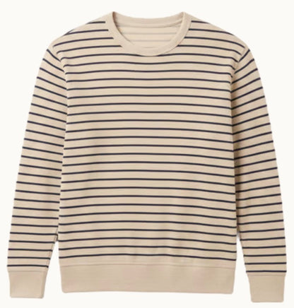 The Faherty Double Knit Crewneck is a beige sweater made from soft Pima cotton with even navy stripes and ribbed cuffs and hem.