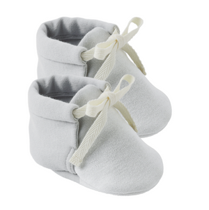 A pair of Quincy Mae Baby Booties in light gray, featuring cream-colored fabric ties and designed for a comfortable fit, displayed on a white background.