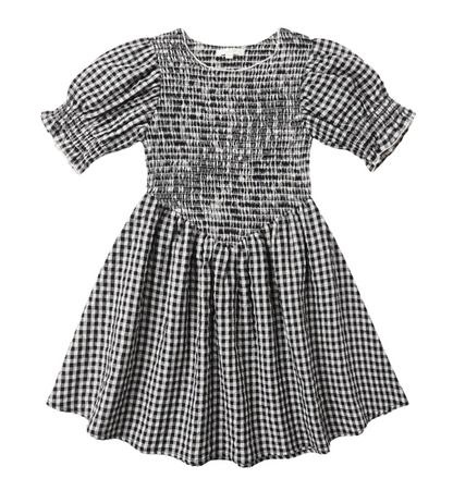 The Girls' Louise Dress by Rylee & Cru features black and white gingham, short puff sleeves, a shirred smocked bodice, and a gathered flared skirt, shown laid flat on a white background.