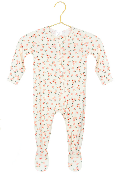 The Lou Lou & Company Baby Girls’ Lottie Zipper Footie features a silky-soft white fabric adorned with a pink floral print, long sleeves, and cozy footed design. Displayed on a gold hanger against a white background, this zippered sleeper is the perfect piece of comfortable baby sleepwear.