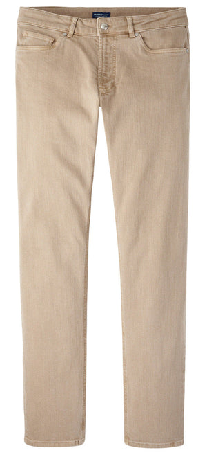 The Peter Millar Fairfield Garment Dyed Denim features beige straight-leg casual pants with button and zip closure, front and back pockets, and cotton stretch fabric, shown laid flat on a white background.