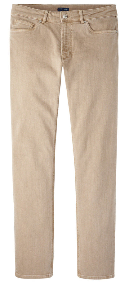 The Peter Millar Fairfield Garment Dyed Denim features beige straight-leg casual pants with button and zip closure, front and back pockets, and cotton stretch fabric, shown laid flat on a white background.