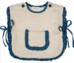 The LL Capuchon Fake Fur Poncho by Louis Louise features a cream sherpa design, blue ruffled edges, blue side ties, a center pocket, and button fastenings at the shoulders.