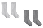 Two pairs of cozy, ribbed Baby Socks from Quincy Mae are displayed side by side on a white background—one pair in light gray and the other in dark gray. This stylish Quincy Mae boxed set is perfect for adding comfort to your little one’s daily routine.