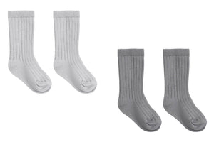 Two pairs of cozy, ribbed Baby Socks from Quincy Mae are displayed side by side on a white background—one pair in light gray and the other in dark gray. This stylish Quincy Mae boxed set is perfect for adding comfort to your little one’s daily routine.