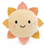 Meet the Baby Sun from Cuddle + Kind: a handcrafted cotton plush featuring a sweet smiling face, rosy cheeks, and alternating yellow and pink crocheted rays. This adorable companion is perfect for baby snuggles and play, all against a charming white background.