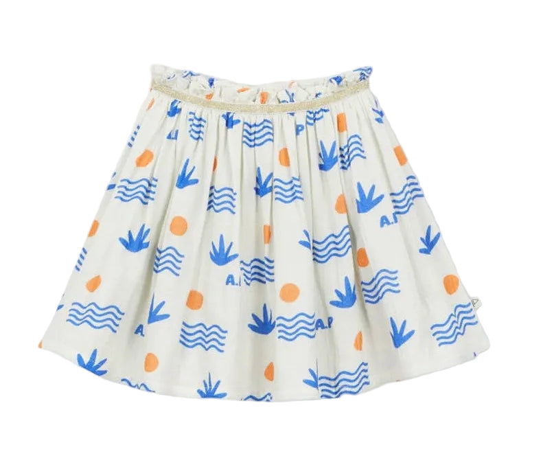 The Girls' Aloe Skirt by Arsene & Les Pipelettes is crafted from organic cotton in a breathable double voile for all-day comfort, featuring a gold elasticated waistband and decorated with blue wave and leaf patterns accented by orange circles, shown against a plain background.