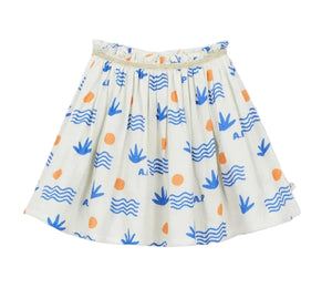 The Girls' Aloe Skirt by Arsene & Les Pipelettes is crafted from organic cotton in a breathable double voile for all-day comfort, featuring a gold elasticated waistband and decorated with blue wave and leaf patterns accented by orange circles, shown against a plain background.