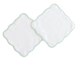 The Terry Tots Wash Cloth Set features two white, square plush wash cloths with scalloped edges and light green striped trim, overlapping on a white background and designed for gentle cleansing.