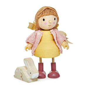 Amy & Her Rabbit by Tender Leaf Toys features a wooden doll with brown hair, a yellow dress, pink shoes, and a pink knitted cardigan standing next to a small white wooden rabbit.