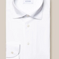 The Eton Four-Way Stretch Shirt, Slim Fit, in white tech fabric features a classic collar and buttoned cuffs. A visible Eton label accents its neatly folded display on a beige background, highlighting exceptional comfort.
