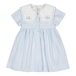 The Kidiwi Baby Girls' and Girls' Paola Dress features sky blue piqué fabric, short sleeves, a white sailor collar with light blue floral embroidery, and front buttons.