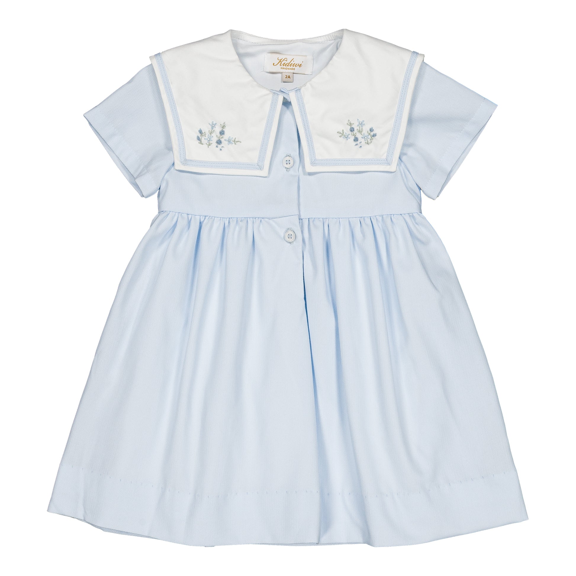 The Kidiwi Baby Girls' and Girls' Paola Dress features sky blue piqué fabric, short sleeves, a white sailor collar with light blue floral embroidery, and front buttons.