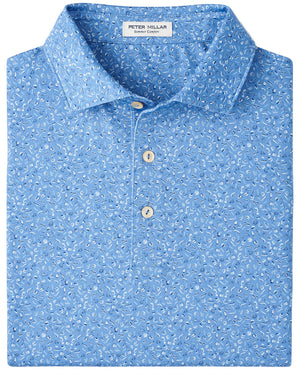The Champagne and Caviar Performance Jersey Polo by Peter Millar is a light blue, short-sleeve polo with a small white paisley pattern, three buttons, four-way stretch, UPF 50+ protection, and an inside collar label.