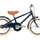 The Banwood Classic Children’s Bicycle, shown in navy blue with cream tires, brown saddle, fenders, and chain guard, is featured in side profile against a white background.
