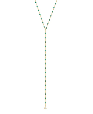 Introducing the Gigi Clozeau Party Y Necklace 19.7", a stunning piece showcasing a gold lariat design embellished with green beads and an eye-catching round pendant, enhanced by elegant resin pearls from the renowned brand Gigi Clozeau.