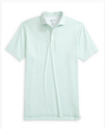 The Michael Polo by Johnnie-O, featuring light green and white stripes, short sleeves, a collared neckline with three buttons, and crafted from moisture-wicking fabric, is shown laid flat on a white background.