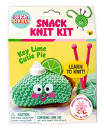 The Snack Knit Kit - Key Lime Pie by Bright Stripes features a cheerful green knitted pie slice with a smile, topped with whipped cream and a lime, plus knitting needles. The packaging includes the phrases "Key Lime Cutie Pie," "Learn to Knit!" and "Ages 8+." Ideal for beginner knitters, this charming craft kit makes learning to knit easy—and deliciously cute!.