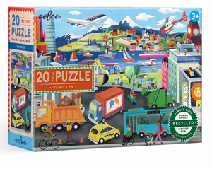 Eeboo Vehicles 20-Piece Puzzle features a vibrant city scene filled with vehicles, people, boats, and buildings. Designed for children ages 3 and up, this puzzle comes in eco-friendly packaging.