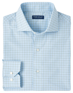A neatly folded Bechet Performance Poplin Sport Shirt by Peter Millar, light blue with a white and blue check pattern, buttoned cuffs, and crafted from UPF 50+ performance fabric. Brand label inside collar.