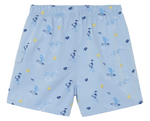 Discover the Boys’ Printed Swim Short by Tartine et Chocolat—light blue swim shorts featuring an elastic waistband and a fun print of ducks on surfboards, suns, and waves in blue and yellow. Perfect for adventurous young explorers ready to make a splash on their next beach trip!.