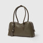 The Ryder Shoulder Bag by Stella McCartney is a structured olive green vegan bag with double handles, silver hardware, and a lock-and-key accent, shown against a plain light background.