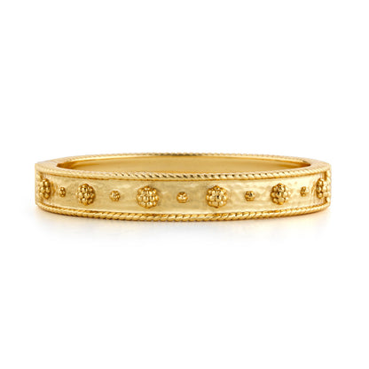 The Berry Classic Hinged Bangle by Juliska Capucine De Wulf features a gold bangle design with raised decorative dots and twisted rope detailing, shown against a white background.