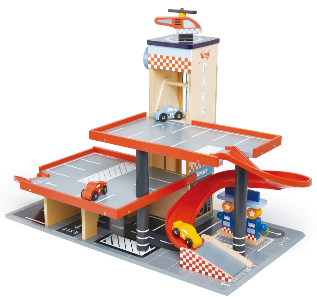 The Tenderleaf Blue Bird Service Station by Tender Leaf Toys is a delightful wooden toy garage featuring three levels, complete with a service station and wooden cars. A helicopter adorns the roof, and a striking red ramp enables easy navigation between floors.