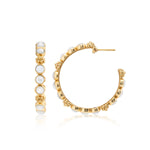 The Juliska Capucine De Wulf Berry Gem Medium Hoop Earrings showcase small white stones and gold beading, pictured in front and side views against a white background.