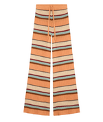 The Guest in Residence Palazzo Pant features a drawstring waist and breathable wide-leg design with horizontal zigzag stripes in orange, beige, blue, and burgundy.