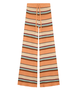 The Guest in Residence Palazzo Pant features a drawstring waist and breathable wide-leg design with horizontal zigzag stripes in orange, beige, blue, and burgundy.