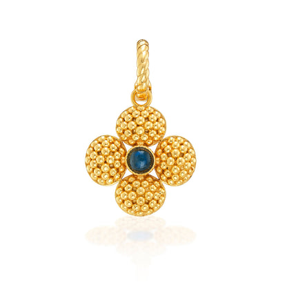 The Juliska Capucine De Wulf Berry Clover Double Sided Pendant features textured petals and a blue gemstone center, suspended on a twisted metal loop—a chic lucky charm necklace for any style.